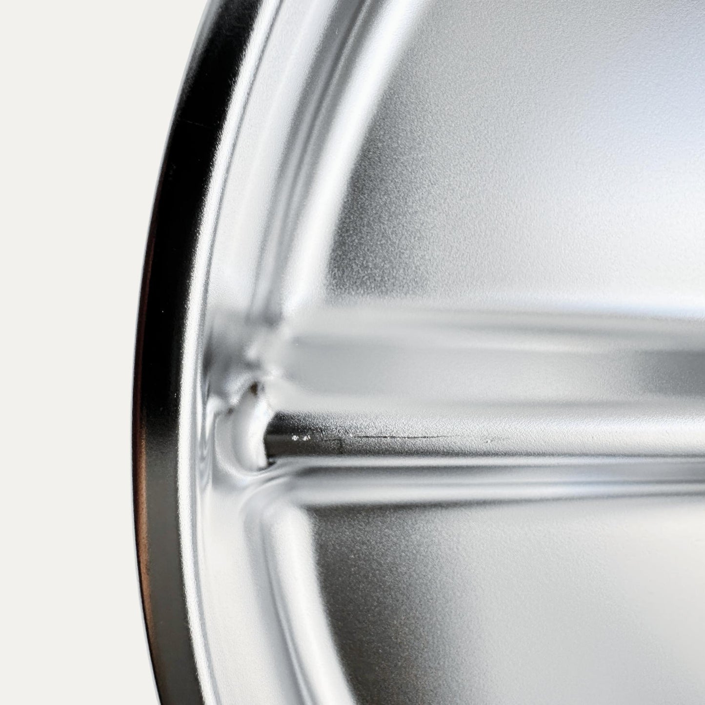 Kids stainless steel round divided plate – closeup of minor cosmetic imperfection (factory seconds).