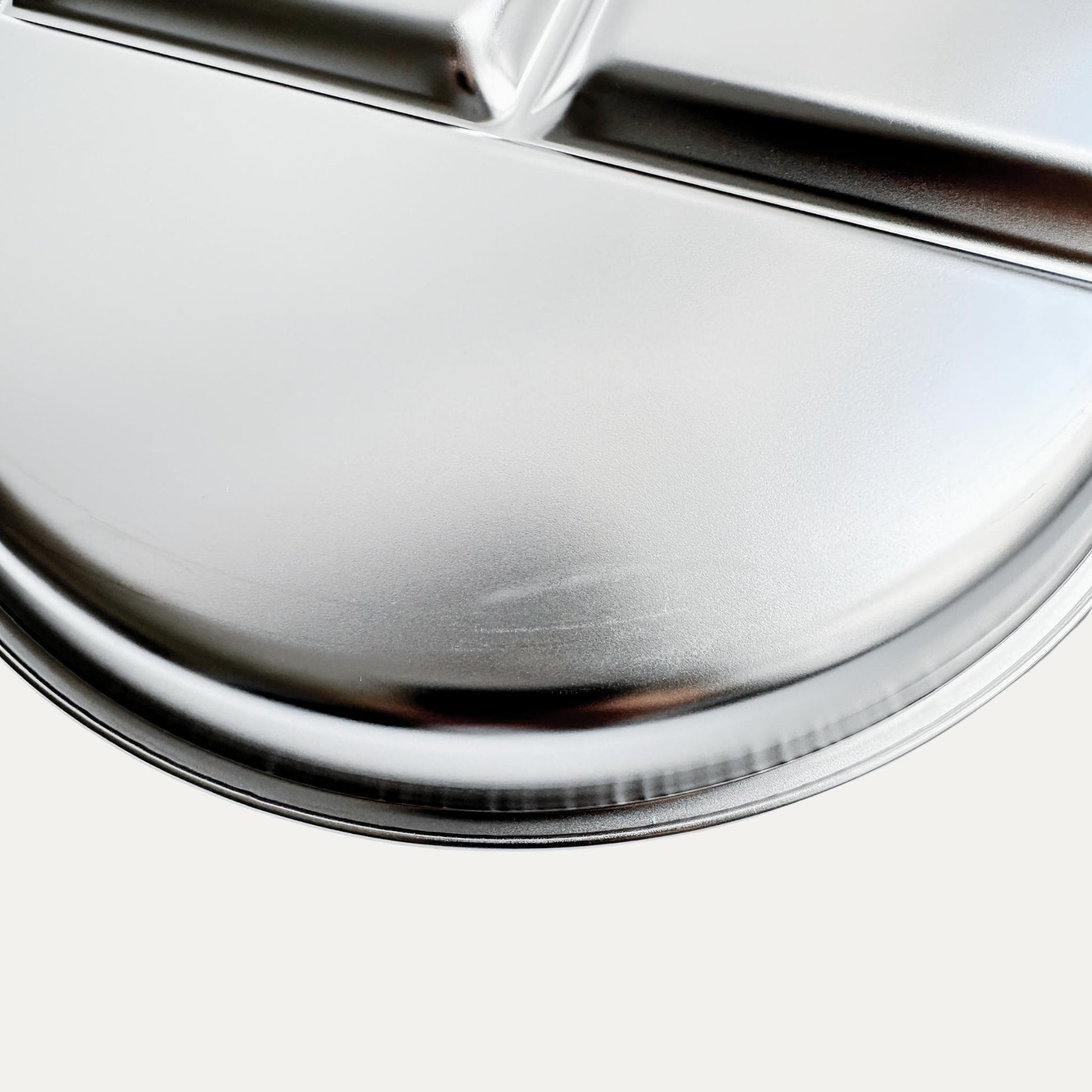Kids stainless steel round divided plate – closeup of minor cosmetic imperfection (factory seconds).