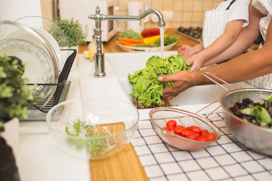 Father rinsing veggies with son to cut microplastic exposure – Greenvyne eco kitchen