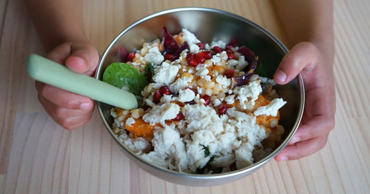child eating pumpkin couscous from stainless steel bowl 15cm sold by greenvyne 
