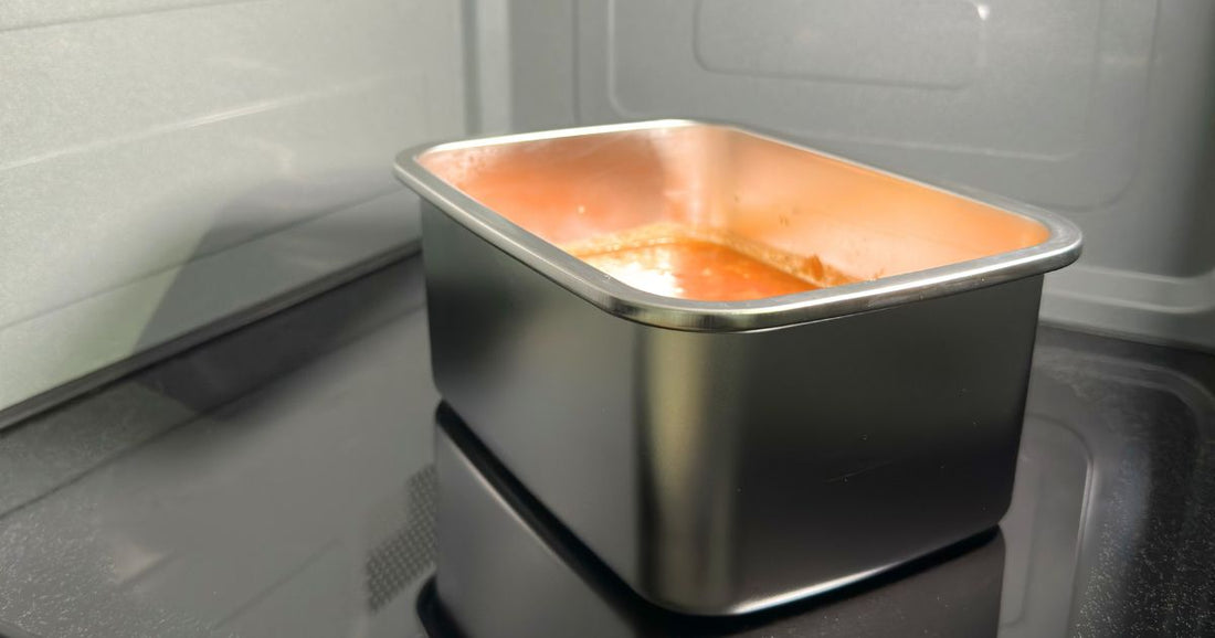 Stainless steel 304 grade food storage container in a microwave with pasta reheating. BPA, phthalates and microplastic free. Greenvyne.
