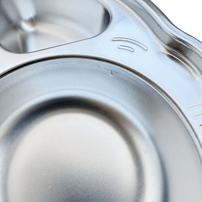 Close-up view of imperfections on a kid's stainless steel seconds car-shaped plate with suction.