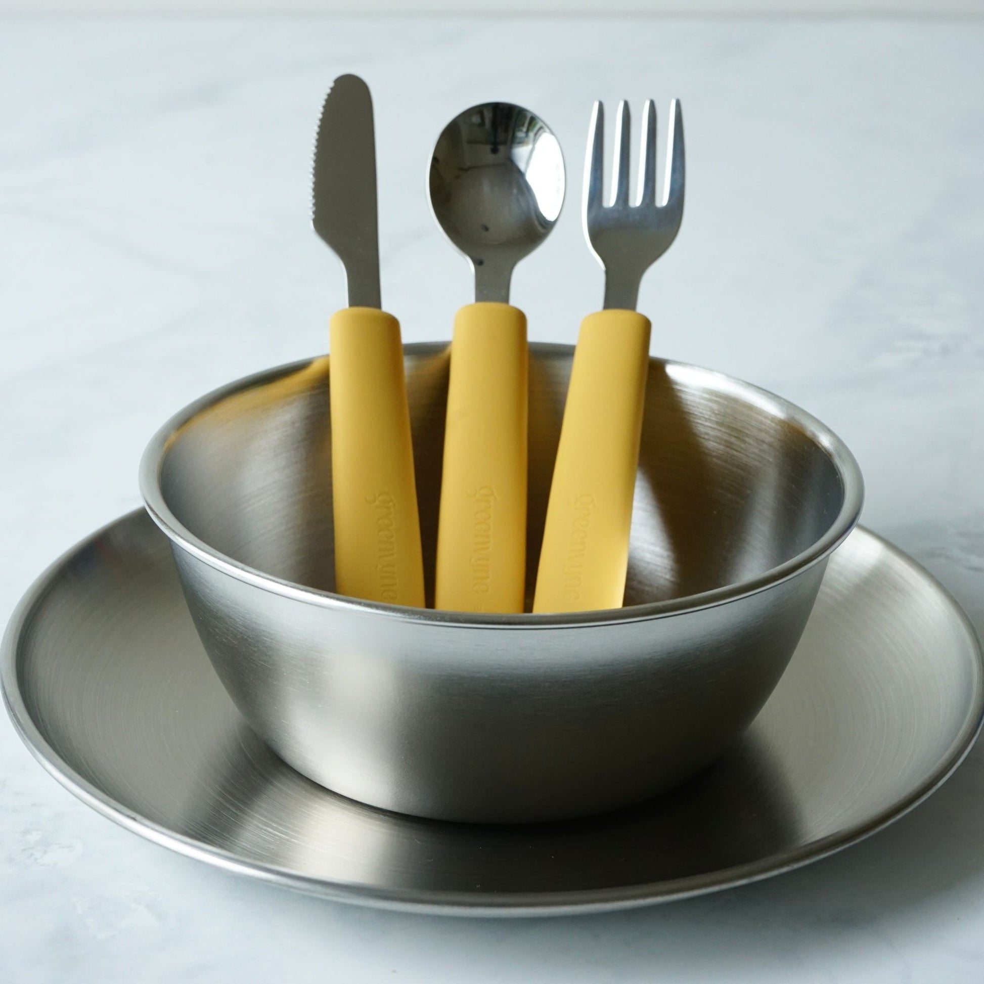 Greenvyne toddler and kids' stainless steel meal time set with plate, bowl and spoon with yellow silicone handle.