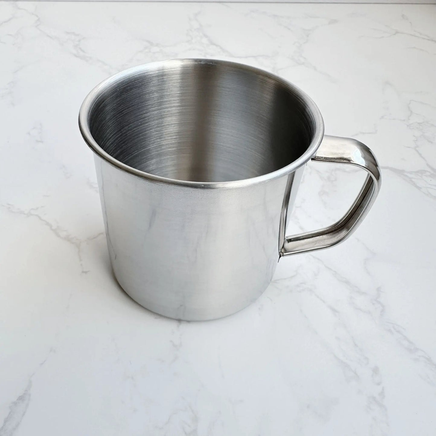 45-degree view of a 250ml stainless steel mug, showcasing its smooth, non-toxic interior and durable design for eco-friendly drinking.