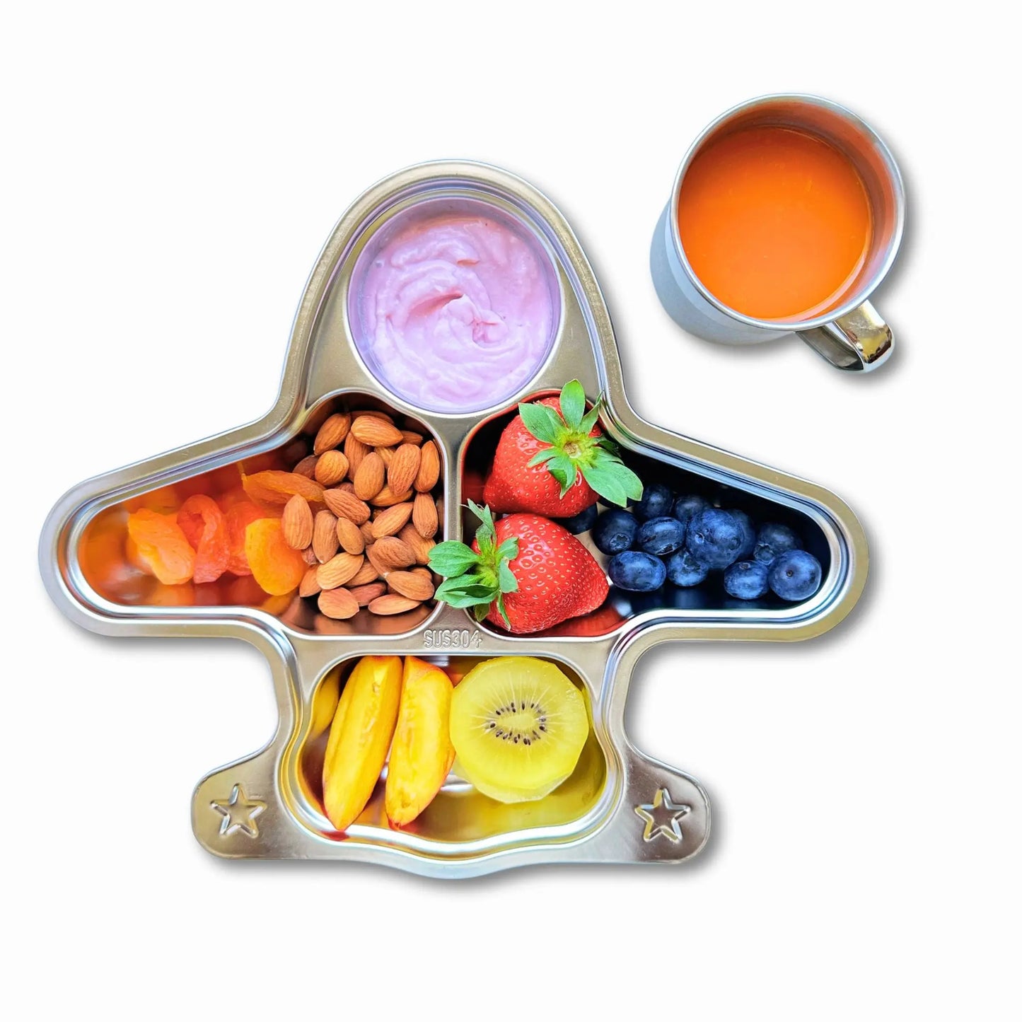 Top view of a kids' stainless steel airplane plate filled with fruits, nuts, and yogurt, alongside a 250ml stainless steel mug with juice, showcasing a fun and eco-friendly mealtime setup.